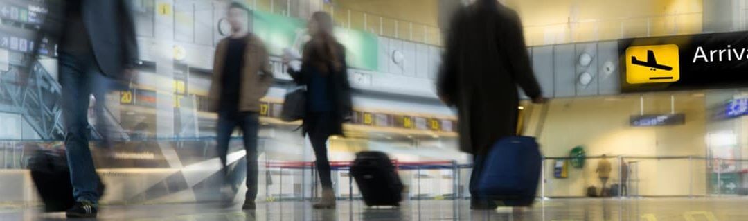 Bringing an SME into an International Market - image - blurry image people walking with suitcases