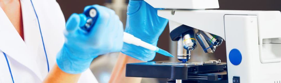 DNA of an Entrepreneur - image - researches in gloves placing pipette into microscope samples