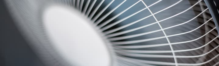 How To Improve The Air Quality Of Your Workplace image - cross section of a white metal electric fan
