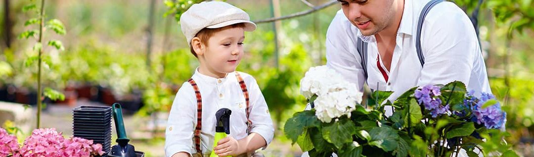 Young child watching a small business owner work in a garden center