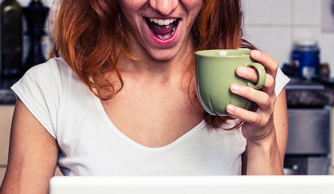 Ecstatic mumpreneur in the kitchen holding a coffee cup