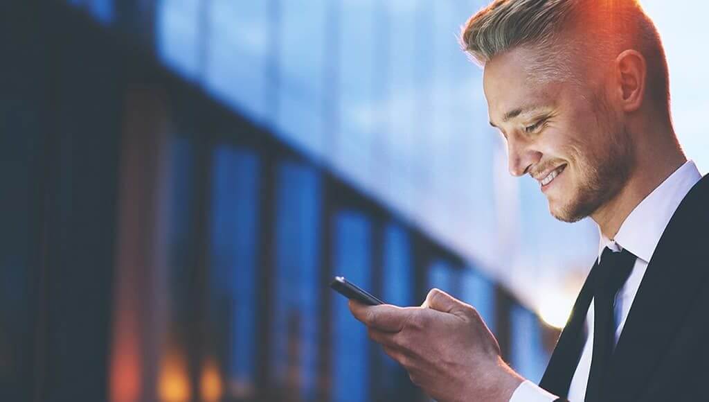 Young entrepreneur in a suit using a mobile phone