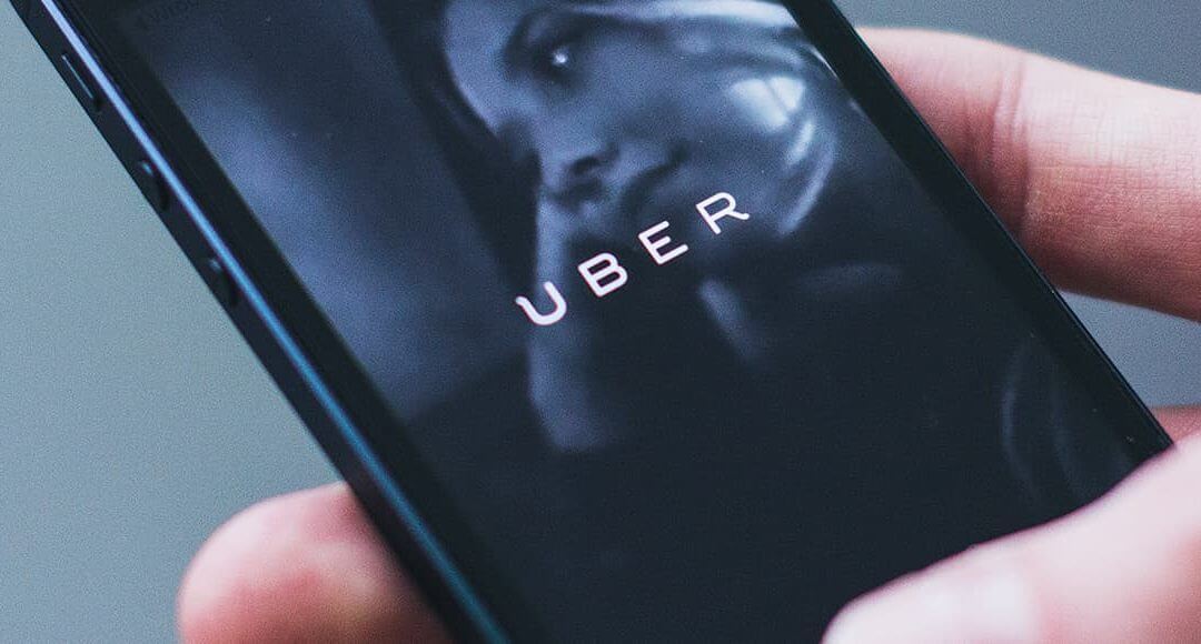 What Is the Uber Ruling and How Will It Affect Small Businesses? image - hand holding phone with uber app open