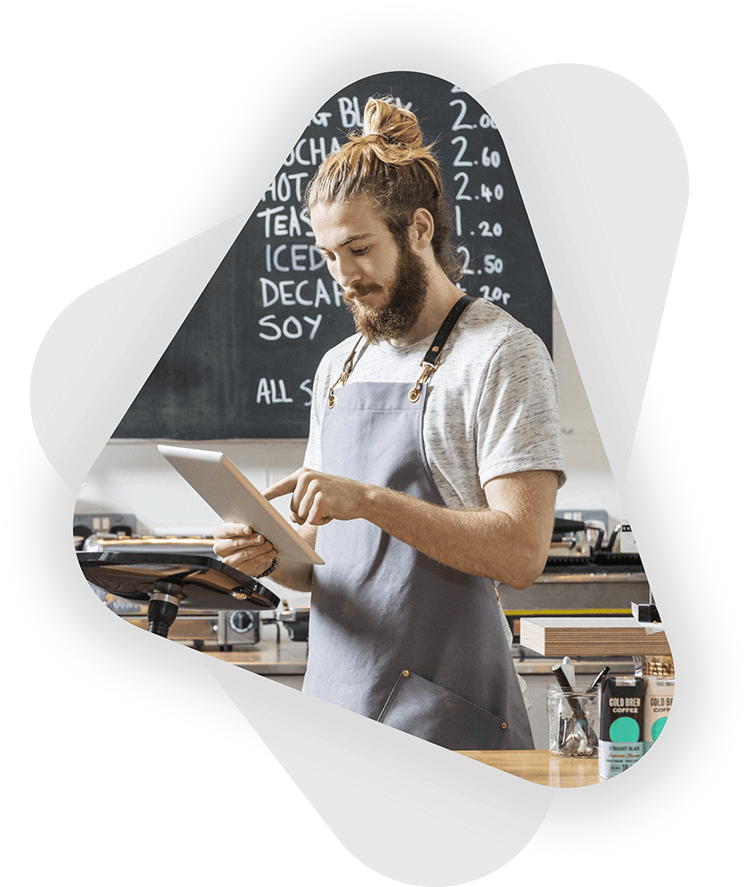 male cafe business owner working on tablet